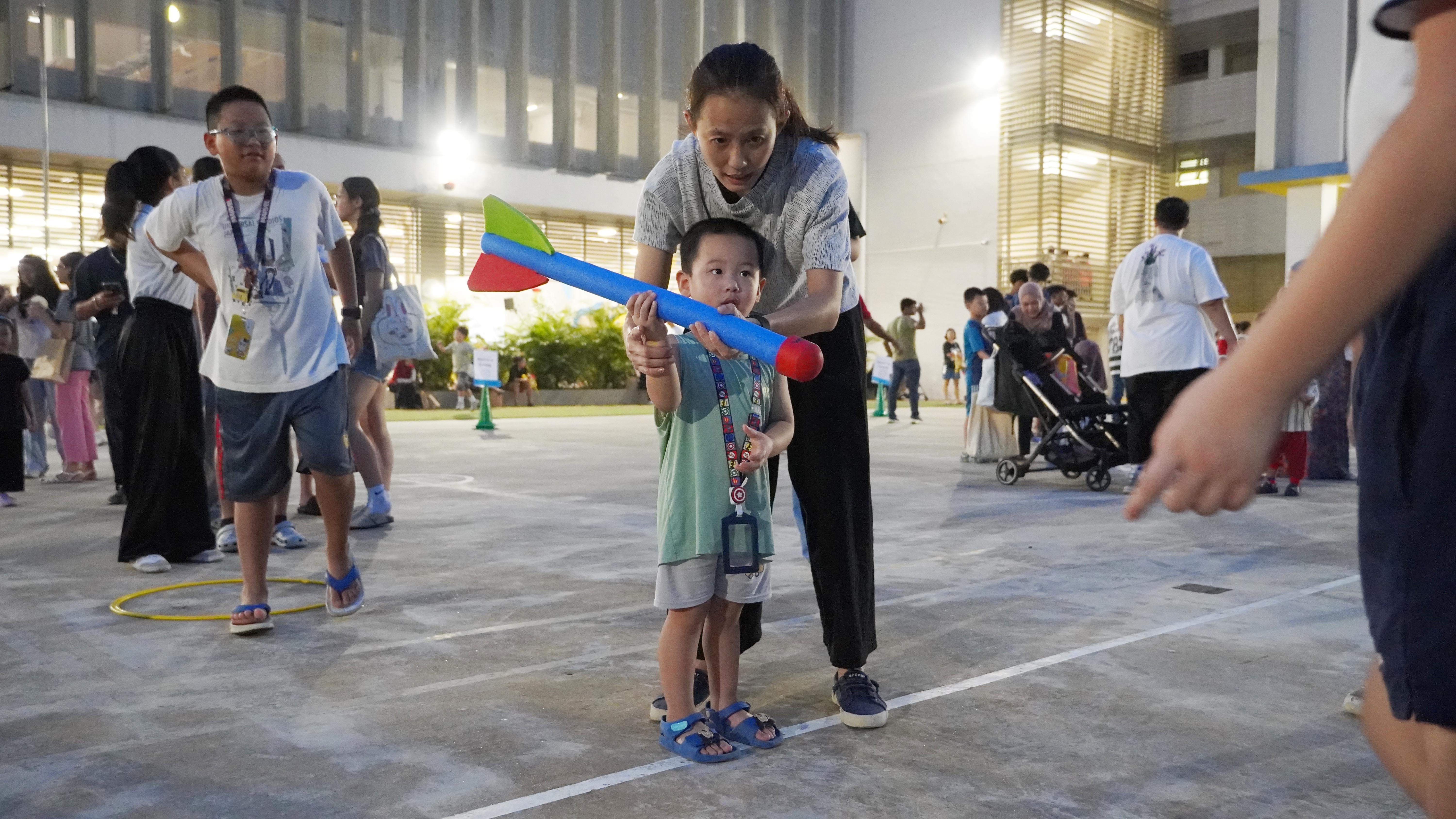 With a little guidance and lots of determination, our young participant gets ready to send the rocket soaring!
